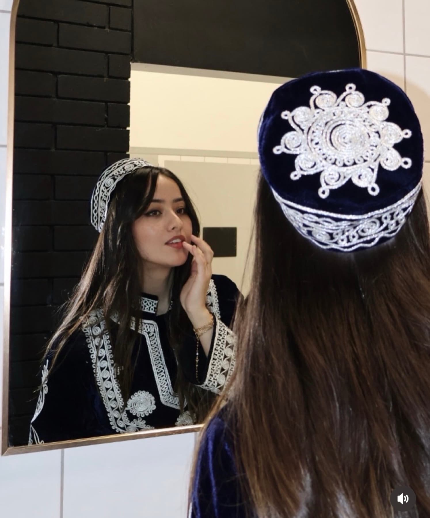 A traditional Afghan outfit with white embroidery.